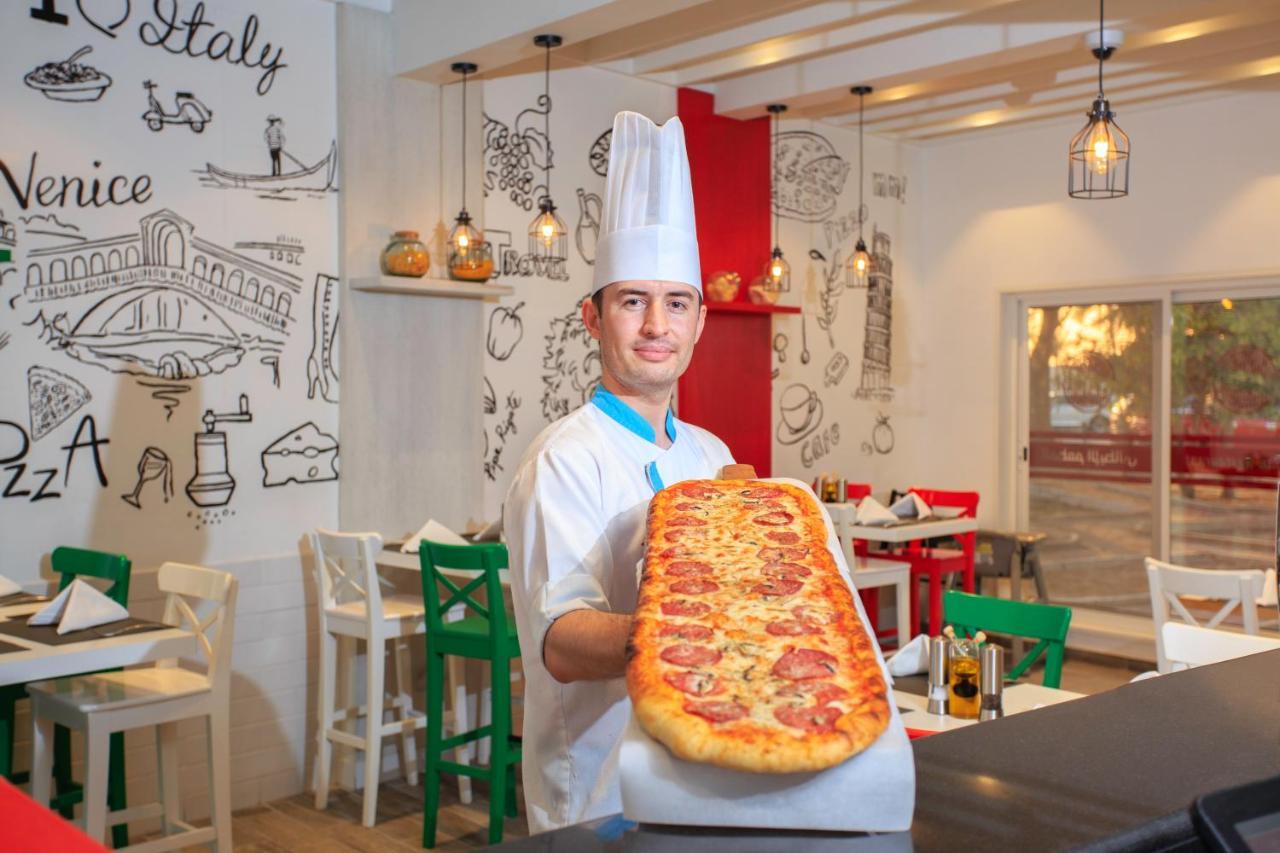 Sealine Beach, A Murwab Resort Mesaieed Luaran gambar A pizzaiolo with a metre-long pizza